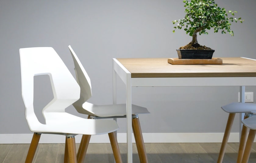 image of 4 white chairs and a table in a gray backgorund